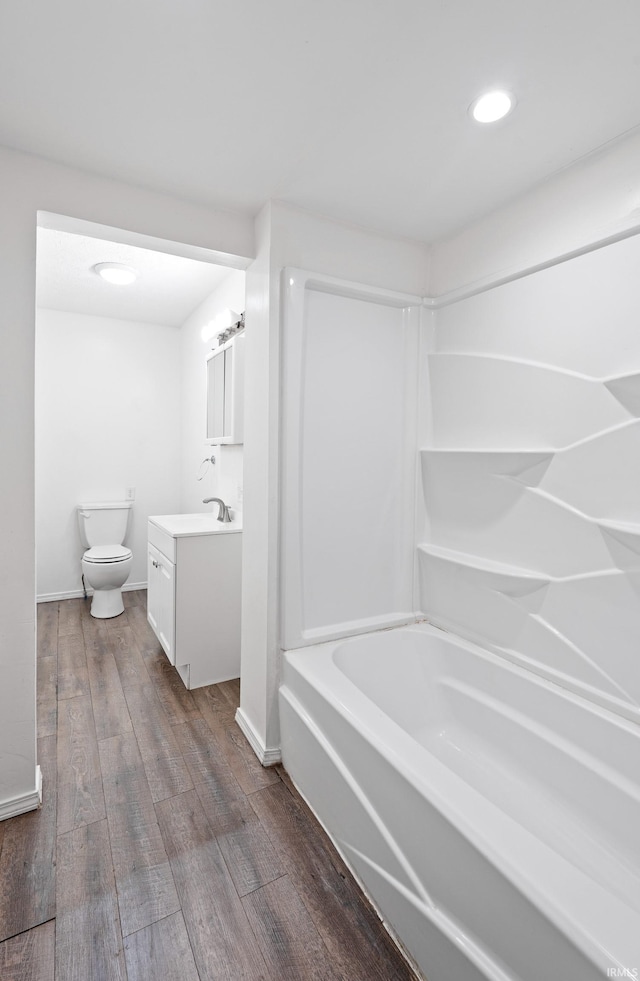 415 N Washington St, Warsaw, IN 46580 - bathroom with vanity, wood finished floors, toilet, recessed lighting, and baseboards