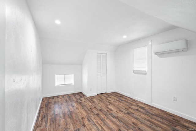 415 N Washington St, Warsaw, IN 46580 - bonus room featuring an AC wall unit, lofted ceiling, dark wood finished floors, baseboards, and recessed lighting