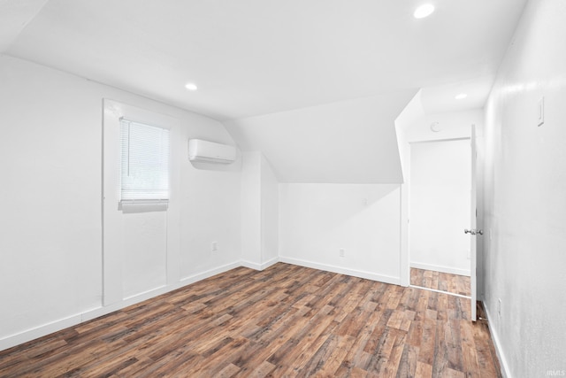 415 N Washington St, Warsaw, IN 46580 - additional living space featuring an AC wall unit, wood finished floors, recessed lighting, vaulted ceiling, and baseboards