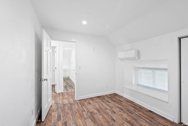 415 N Washington St, Warsaw, IN 46580 - additional living space with a wall mounted AC, baseboards, wood finished floors, lofted ceiling, and recessed lighting
