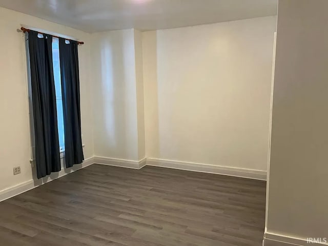 415 N Washington St, Warsaw, IN 46580 - unfurnished room with dark wood-type flooring and baseboards