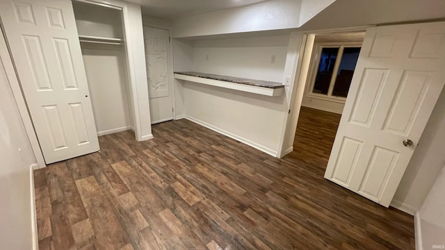 415 N Washington St, Warsaw, IN 46580 - unfurnished bedroom with dark wood-style flooring and baseboards