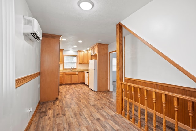 415 N Washington St, Warsaw, IN 46580 - kitchen with white appliances, a wall mounted air conditioner, light countertops, light wood-type flooring, and recessed lighting