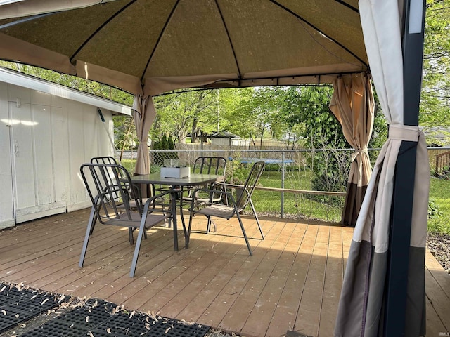 2702 Eastern Ave, Bedford, IN 47421 - wooden deck with a gazebo, outdoor dining space, and a fenced backyard