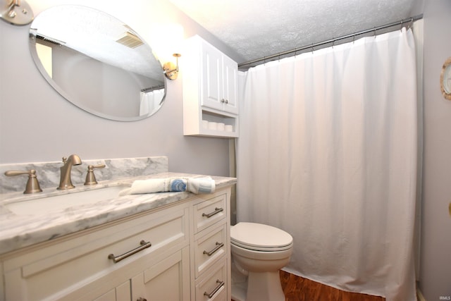 9428 S Lake Ridge Dr, Bloomington, IN 47401 - full bathroom with vanity, wood finished floors, toilet, and a textured ceiling
