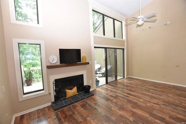 9428 S Lake Ridge Dr, Bloomington, IN 47401 - living room with plenty of natural light, high vaulted ceiling, wood finished floors, a tile fireplace, and ceiling fan