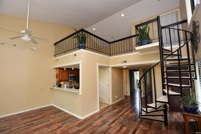 9428 S Lake Ridge Dr, Bloomington, IN 47401 - unfurnished living room with stairway, a ceiling fan, dark wood-style flooring, baseboards, and recessed lighting