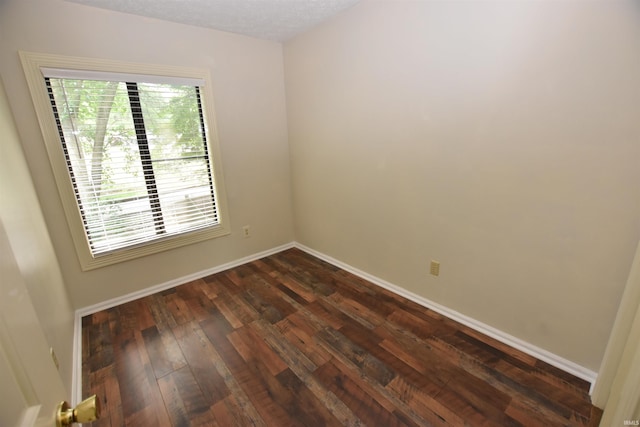 9428 S Lake Ridge Dr, Bloomington, IN 47401 - unfurnished room featuring dark wood-type flooring and baseboards