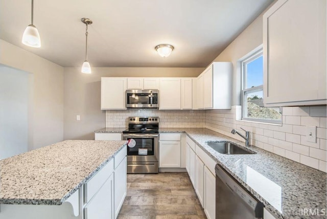 405 Somerfield Dr, Lakeville, IN 46536 - kitchen featuring stainless steel appliances, a sink, light wood-type flooring, and white cabinets