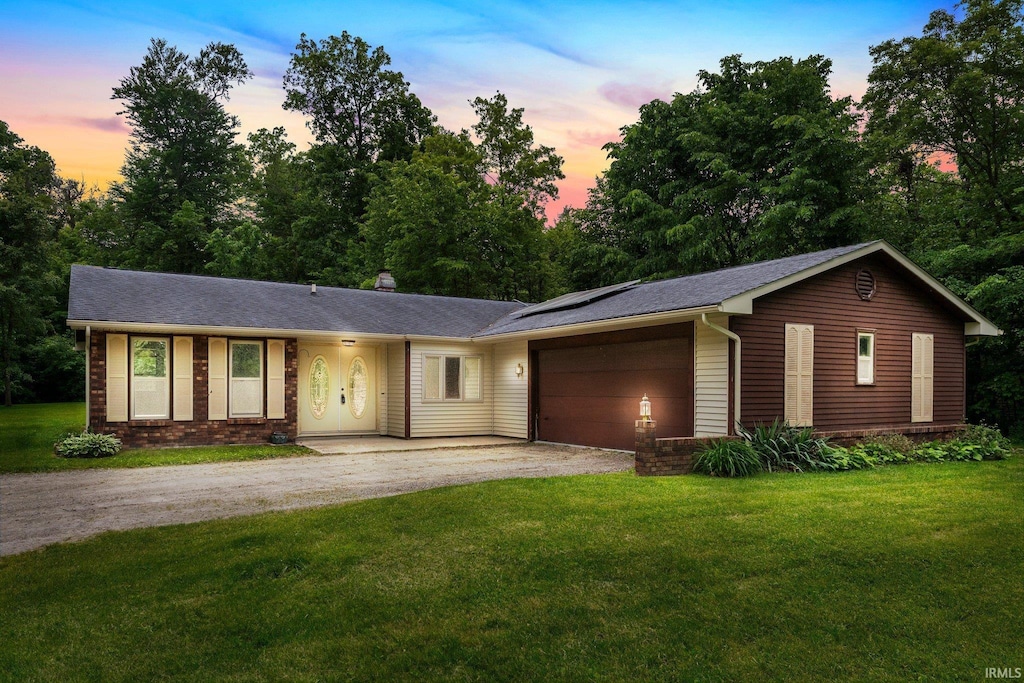 6120 E Paulding Rd, Fort Wayne, IN 46816 - ranch-style home with asphalt driveway, an attached garage, a front yard, and brick siding