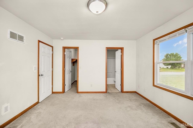 18310 Gyr Ct, New Paris, IN 46553 - unfurnished bedroom with baseboards, light colored carpet, a walk in closet, and connected bathroom