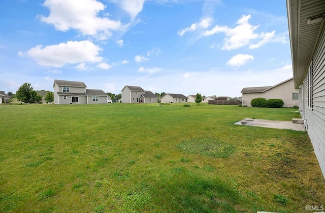 18310 Gyr Ct, New Paris, IN 46553 - view of grassy yard with a residential view and a patio