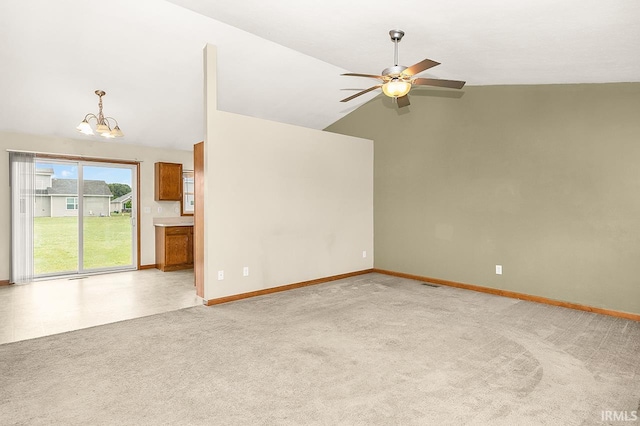 18310 Gyr Ct, New Paris, IN 46553 - empty room with ceiling fan, a chandelier, lofted ceiling, baseboards, and light colored carpet