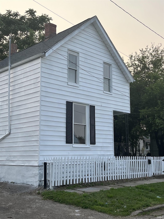 514 N Elliott St, Evansville, IN 47711 - view of property exterior featuring a fenced front yard and a chimney
