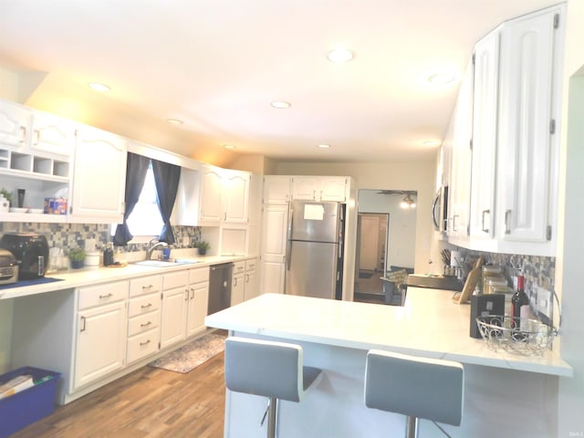 53341 Crestview Dr, South Bend, IN 46635 - kitchen with appliances with stainless steel finishes, a peninsula, white cabinetry, a sink, and recessed lighting