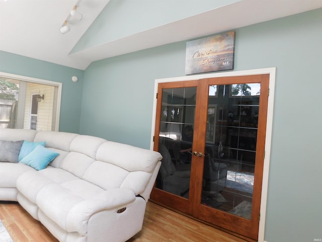53341 Crestview Dr, South Bend, IN 46635 - living room featuring lofted ceiling, wood finished floors, track lighting, french doors, and healthy amount of natural light