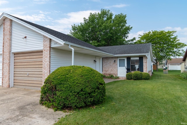 1009 Berkley Cir, Mishawaka, IN 46544 - view of front facade with an attached garage, brick siding, a shingled roof, and a front lawn
