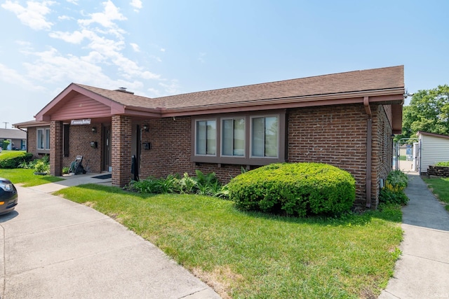 1009 Berkley Cir, Mishawaka, IN 46544 - ranch-style house with brick siding, a front yard, and a shingled roof