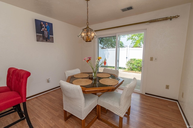 1009 Berkley Cir, Mishawaka, IN 46544 - dining room with wood finished floors, baseboards, and a chandelier