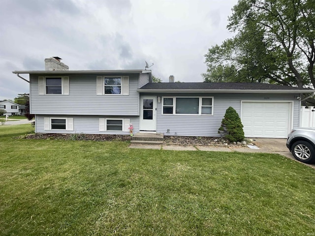 2659 Castine Walk, Mishawaka, IN 46544 - split level home with a garage, a front lawn, and a chimney