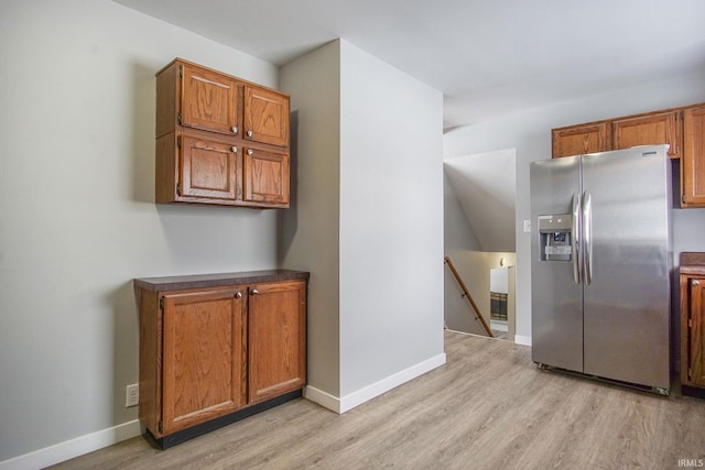 2659 Castine Walk, Mishawaka, IN 46544 - kitchen featuring stainless steel fridge, light wood-style floors, brown cabinets, and baseboards