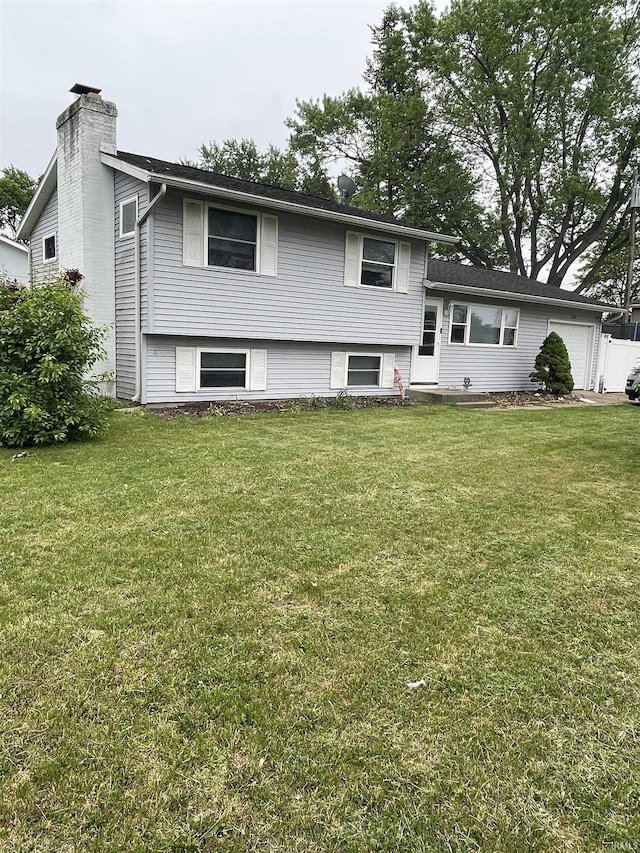 2659 Castine Walk, Mishawaka, IN 46544 - tri-level home featuring a chimney, an attached garage, and a front yard