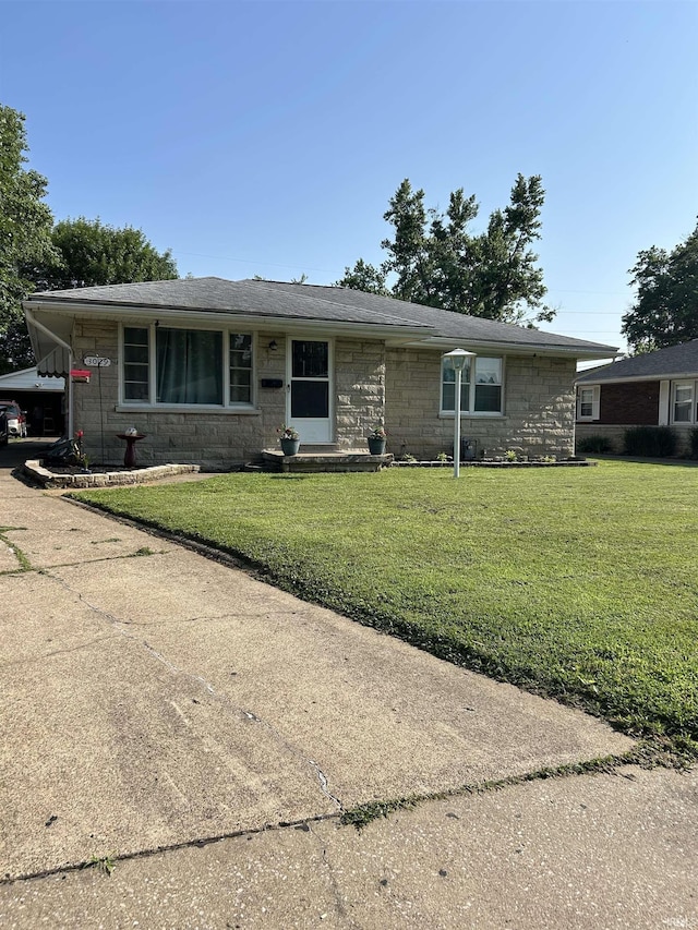 3029 Graham Ave, Evansville, IN 47714 - view of front facade featuring a front lawn, stone siding, and concrete driveway