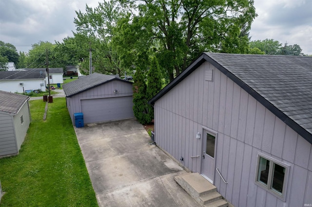 614 E S B St, Gas City, IN 46933 - view of property exterior with a detached garage, a lawn, an outbuilding, and roof with shingles