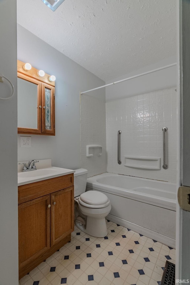 1113 E 500 S, Wabash, IN 46992 - bathroom featuring shower / bath combination, vanity, toilet, and a textured ceiling