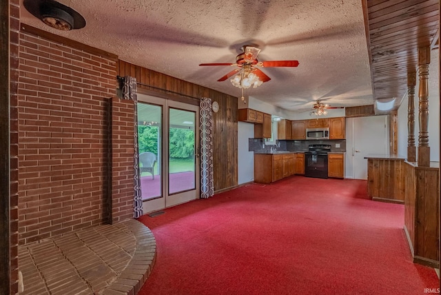 1113 E 500 S, Wabash, IN 46992 - kitchen with electric range, stainless steel microwave, brown cabinets, a ceiling fan, and a textured ceiling