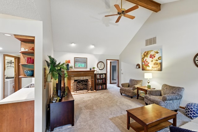 5816 Bayside Dr, Fort Wayne, IN 46815 - carpeted living room with high vaulted ceiling, ceiling fan, beamed ceiling, a brick fireplace, and recessed lighting