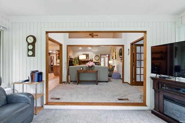 5816 Bayside Dr, Fort Wayne, IN 46815 - living room featuring carpet floors, wood walls, and a ceiling fan