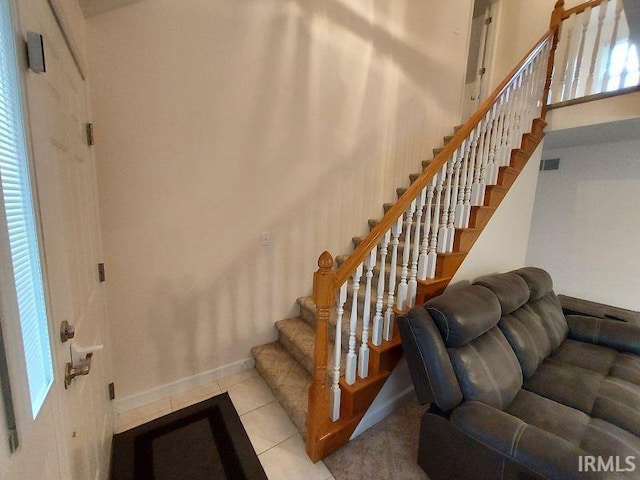1749 W 1st St, Jasper, IN 47546 - staircase with tile patterned floors, baseboards, and a towering ceiling