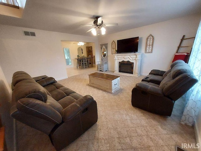 1749 W 1st St, Jasper, IN 47546 - living area featuring a ceiling fan, carpet flooring, a fireplace, and healthy amount of natural light