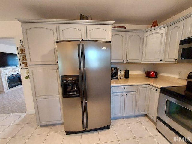 1749 W 1st St, Jasper, IN 47546 - kitchen with appliances with stainless steel finishes, light tile patterned floors, and light countertops