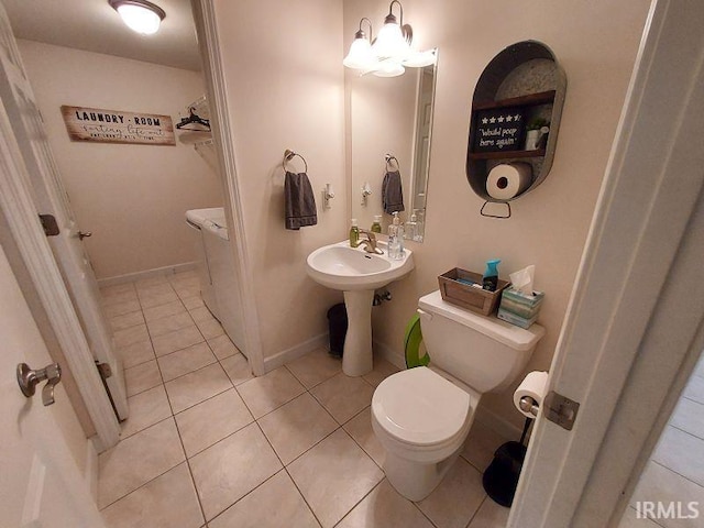 1749 W 1st St, Jasper, IN 47546 - bathroom with toilet, tile patterned flooring, a chandelier, and baseboards