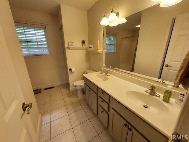 1749 W 1st St, Jasper, IN 47546 - bathroom with a shower, toilet, double vanity, tile patterned flooring, and baseboards