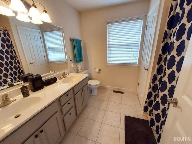 1749 W 1st St, Jasper, IN 47546 - full bath with double vanity, tile patterned floors, toilet, a chandelier, and baseboards