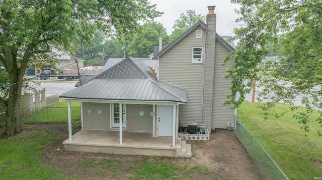208 N Heaton St, Knox, IN 46534 - rear view of house featuring covered porch, a chimney, and metal roof