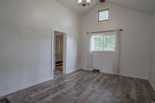 208 N Heaton St, Knox, IN 46534 - empty room with healthy amount of natural light, wood finished floors, a chandelier, high vaulted ceiling, and baseboards