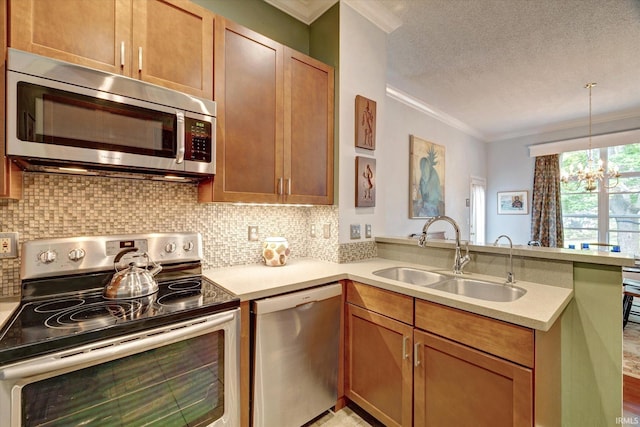 723 E Moss Creek Dr, Bloomington, IN 47401 - kitchen featuring stainless steel appliances, a sink, a peninsula, ornamental molding, and a chandelier