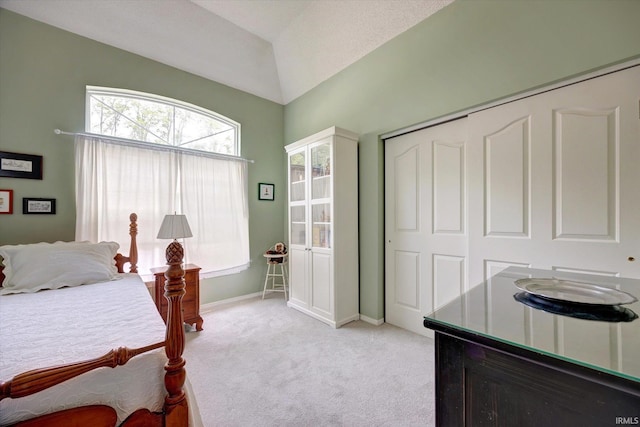 723 E Moss Creek Dr, Bloomington, IN 47401 - bedroom featuring light colored carpet, a closet, lofted ceiling, and baseboards