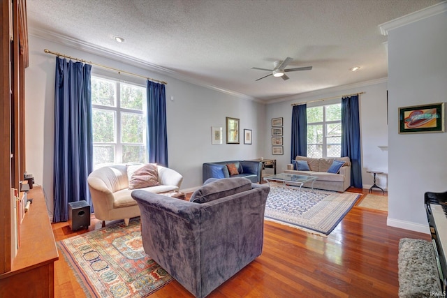 723 E Moss Creek Dr, Bloomington, IN 47401 - living area with ornamental molding, ceiling fan, wood finished floors, a textured ceiling, and baseboards