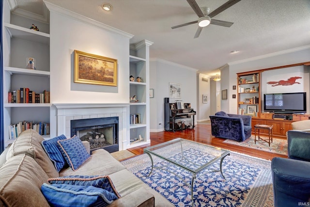 723 E Moss Creek Dr, Bloomington, IN 47401 - living area with built in shelves, wood finished floors, crown molding, a ceiling fan, and baseboards