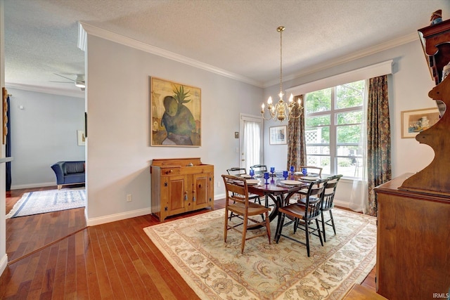 723 E Moss Creek Dr, Bloomington, IN 47401 - dining space featuring a textured ceiling, wood-type flooring, a chandelier, ornamental molding, and baseboards