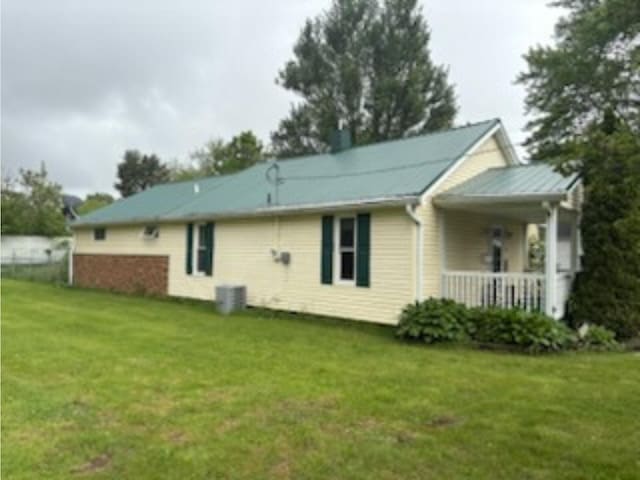 1144 E 30th St, Marion, IN 46953 - rear view of house featuring a yard, covered porch, and central AC unit