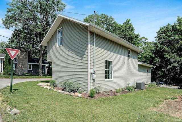 501 Spring Beach Rd, Rome City, IN 46784 - view of side of property with central air condition unit and a yard