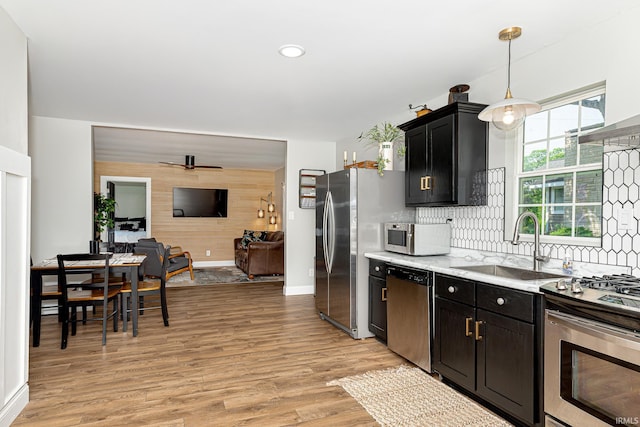 501 Spring Beach Rd, Rome City, IN 46784 - kitchen with appliances with stainless steel finishes, a sink, light countertops, and light wood finished floors