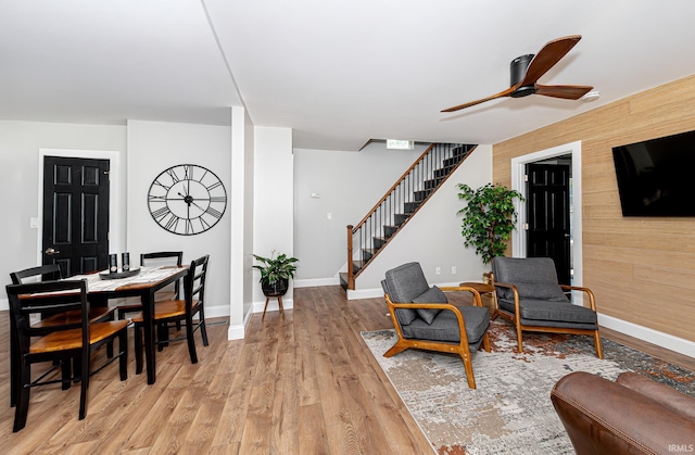 501 Spring Beach Rd, Rome City, IN 46784 - living area featuring stairs, a ceiling fan, light wood-style floors, and baseboards