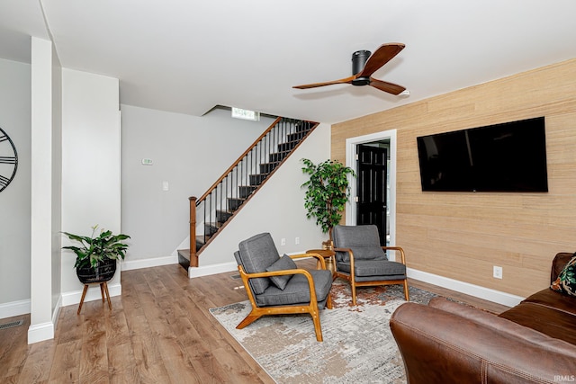 501 Spring Beach Rd, Rome City, IN 46784 - living area featuring stairway, a ceiling fan, wood finished floors, baseboards, and wood walls